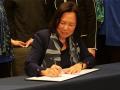 SSU president Judy Sakaki signing commitment to sustainability
