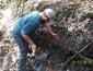 Man installing erosion pins in creek bank