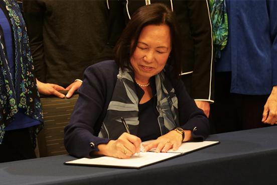 SSU president Judy Sakaki signing commitment to sustainability