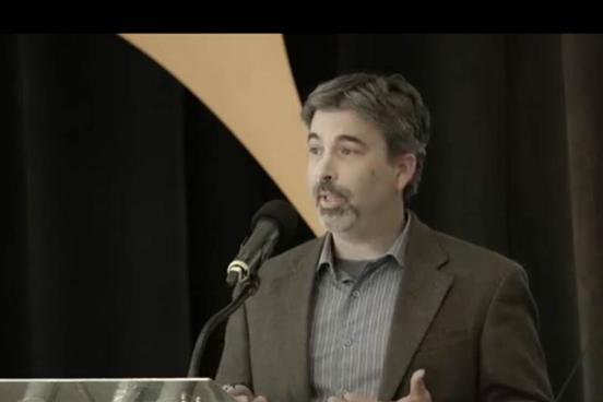 Man speaking at a podium