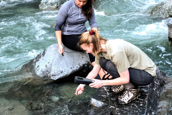 Students taking water samples in creek