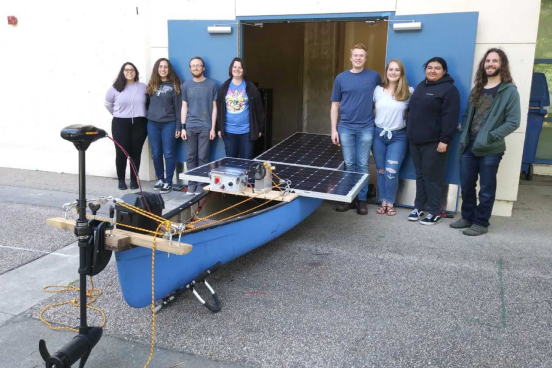 Students posing with their solar powered boat