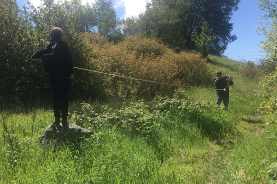 Two students assess blackberry along a transect line 