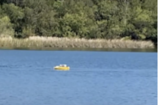 small drone boat on lake