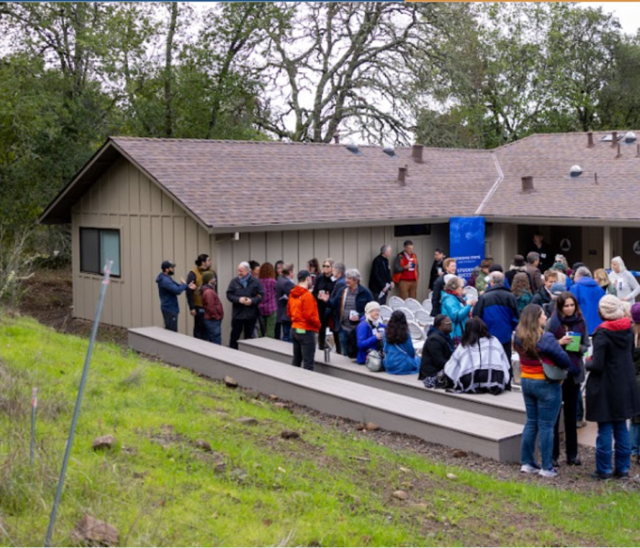 people in front of a building in nature