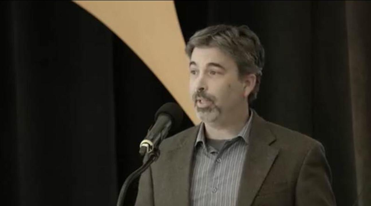 Man speaking at a podium