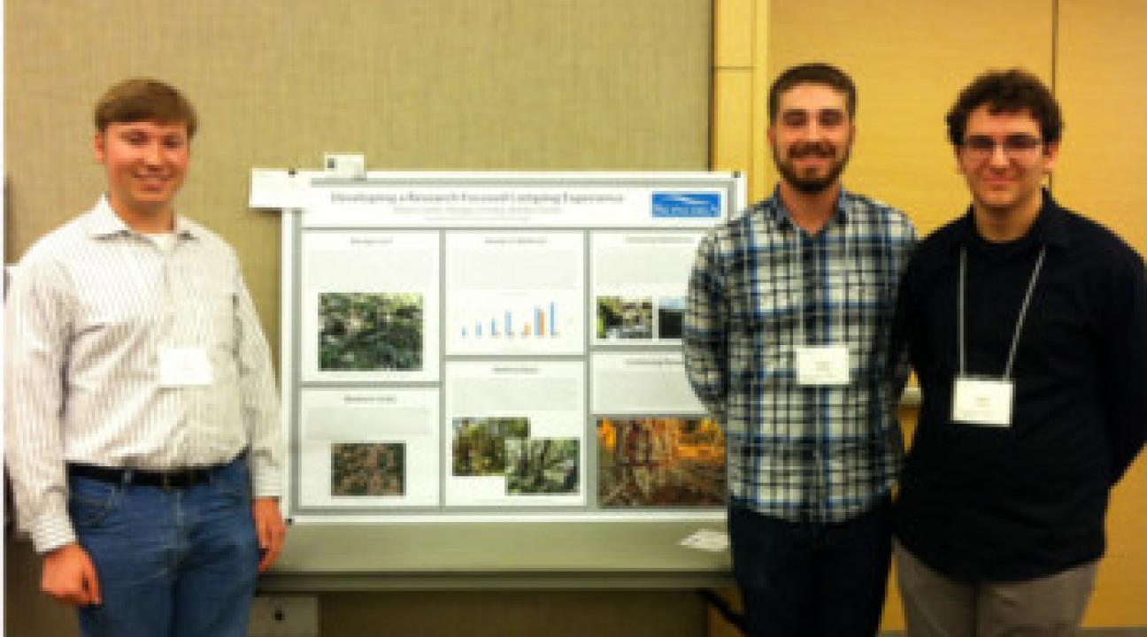 Students presenting a poster at the 2016 symposium