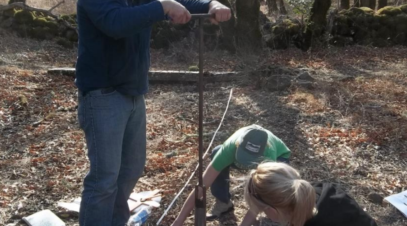Students collecting samples with a soil auger