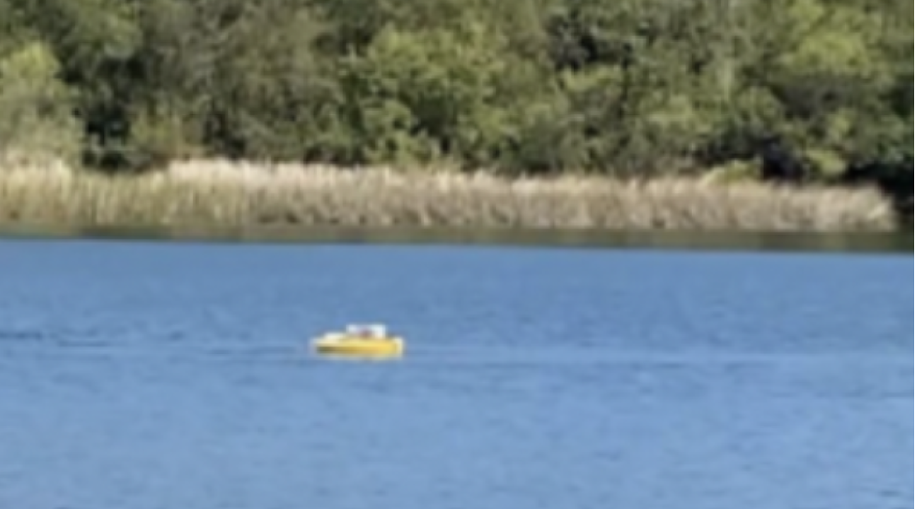 small drone boat on lake