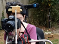 woman looking into a camera using assistive technology on wheelchair