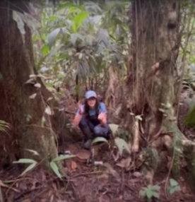 Person sampling microbial ecosystem in the rainforest