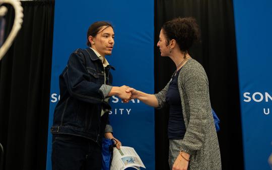 Shin Tadokoro accepts award from Kerry Wininger at the 2025 RSC Symposium