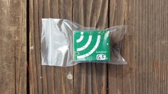 small green circuit board in plastic ziploc bag