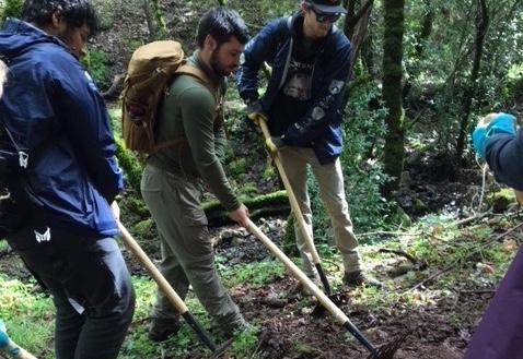 men with outdoor hand tools