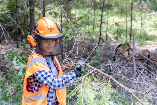 Student clearing brush at Galbreath Preserve