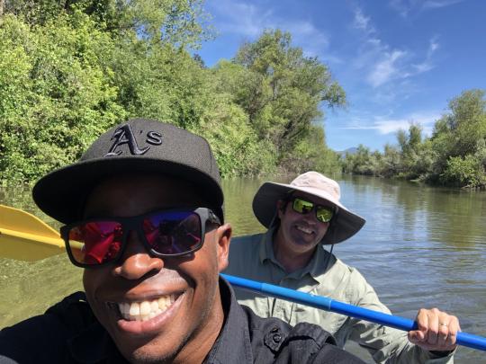 Dr. Manza Atkinson and researcher on boat