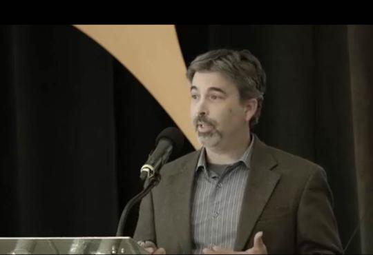 Man speaking at a podium