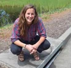 Student squatting over sewer drain