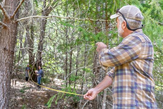 Andy Balestracci measures a clearing at Galbreath