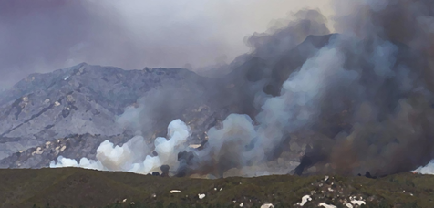 smoke rising from a mountain