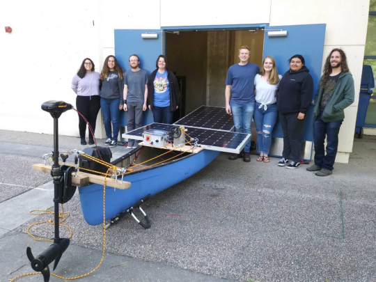 Students posing with their solar powered boat