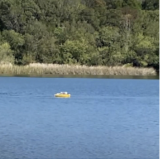 small drone boat on lake