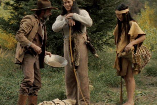 a gold rusher and two native americans talk