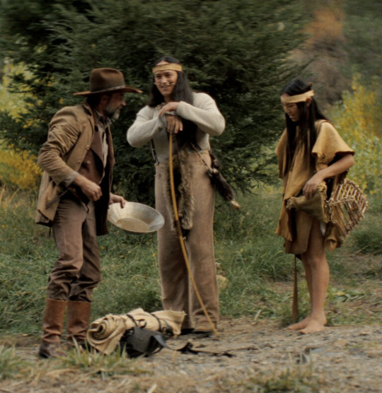 a gold rusher and two native americans talk