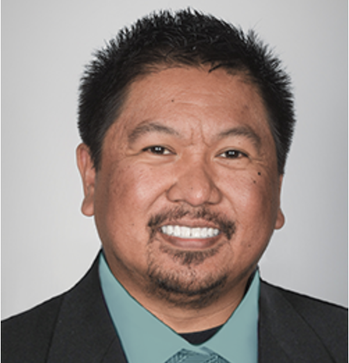a man in a suit smiles